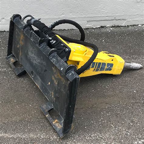 skid steer hanging from crane jack hammering|hydraulic skid steer attachment rental.